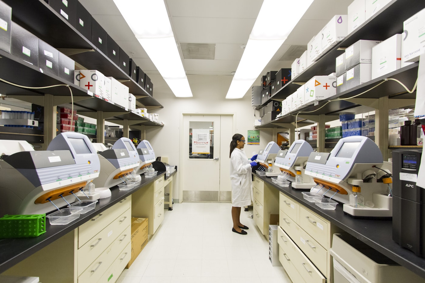 A pharmacist in a white coat working in a pharmacy laboratory